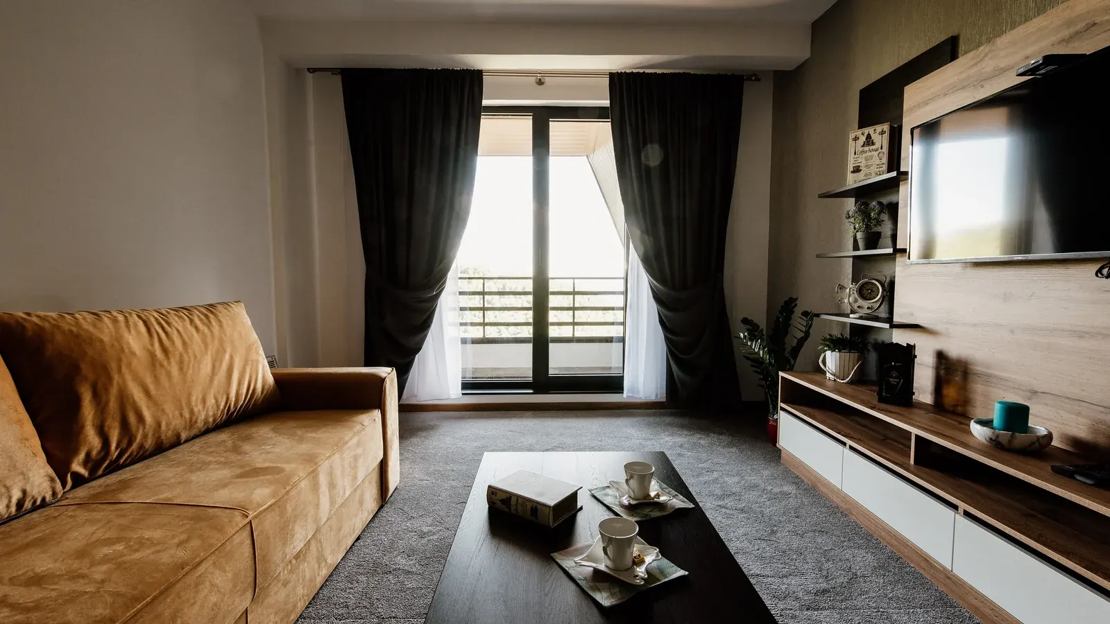 Modern living room with a sofa, coffee table, and wall-mounted television