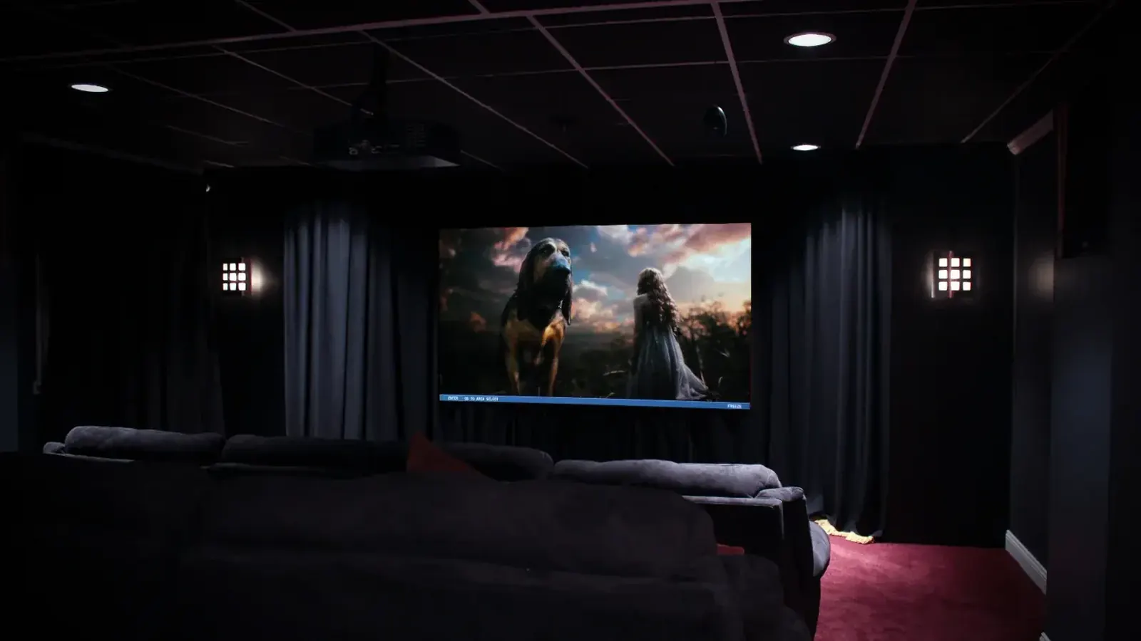 Home theater room with a projector screen and rows of seating