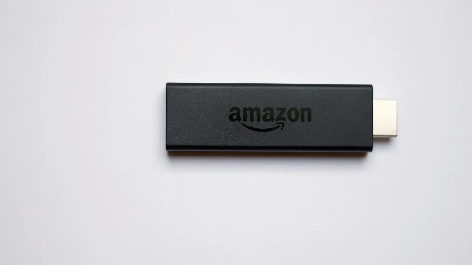 Amazon Fire TV streaming stick remote control on a plain background