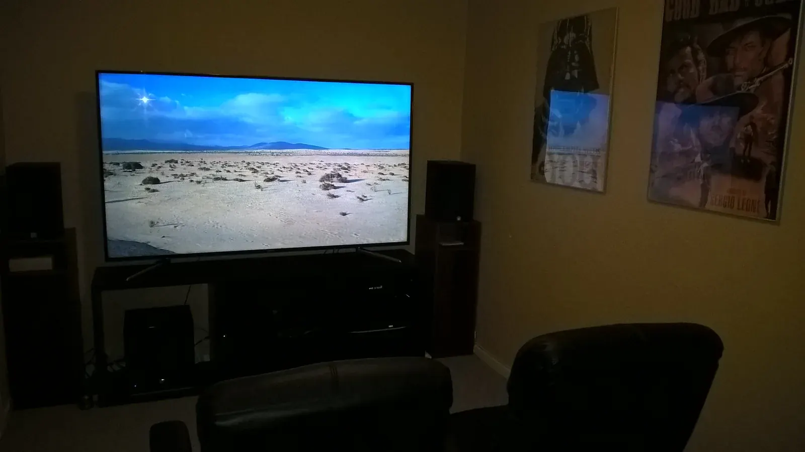 Large television playing a film in a modern home theater room