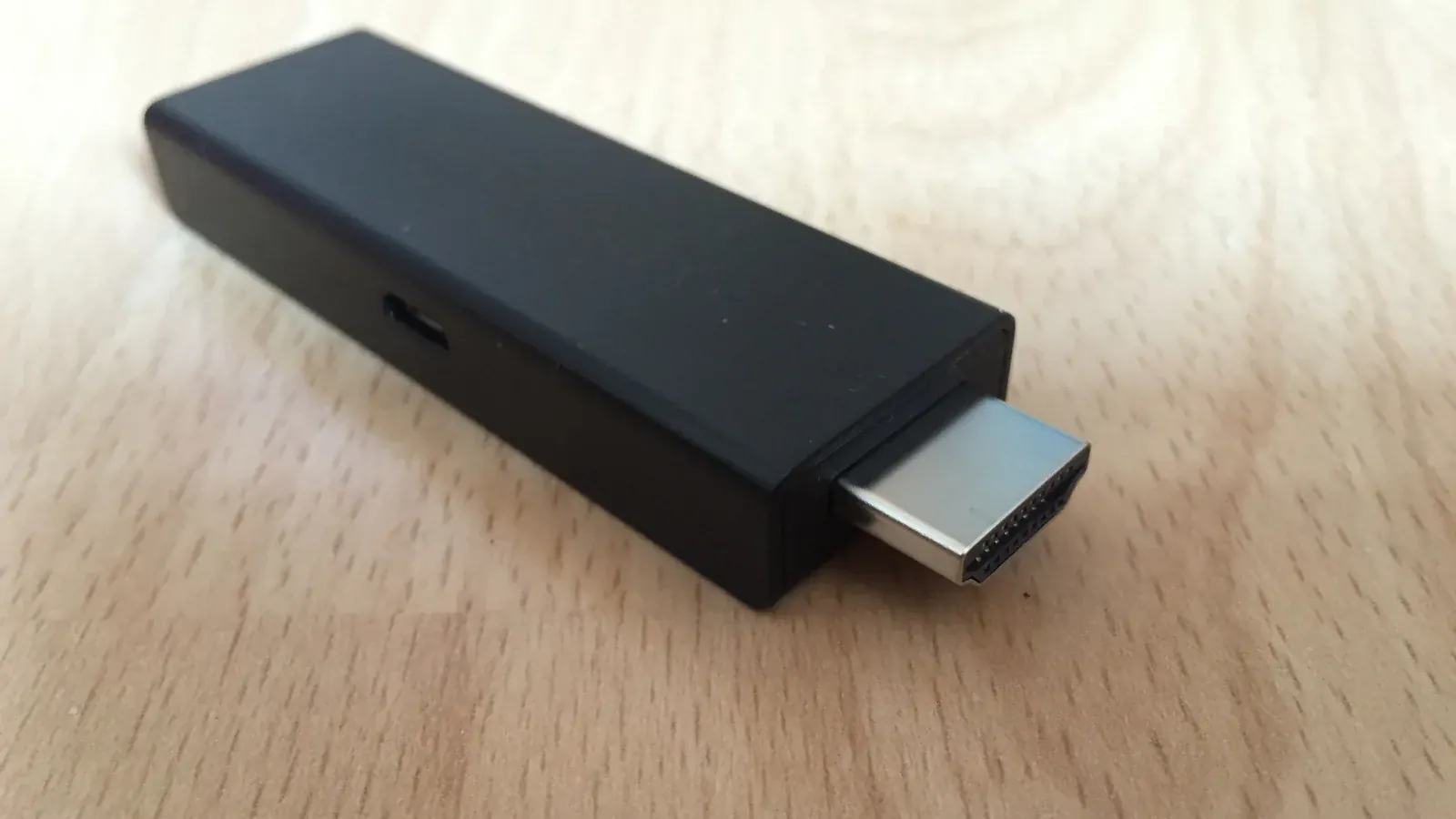 Close-up of an HDMI streaming stick on a wooden table