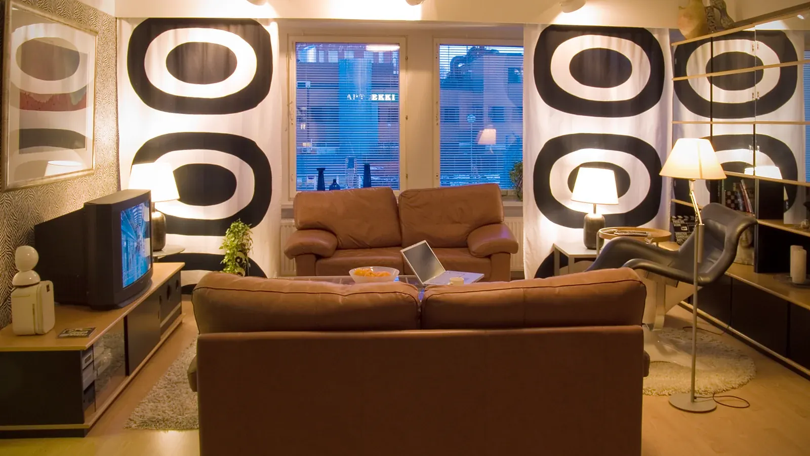 Living room with a television playing content in the evening